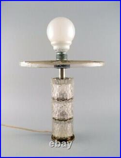 Scandinavian designer table lamp in steel and art glass. Mid-20th century